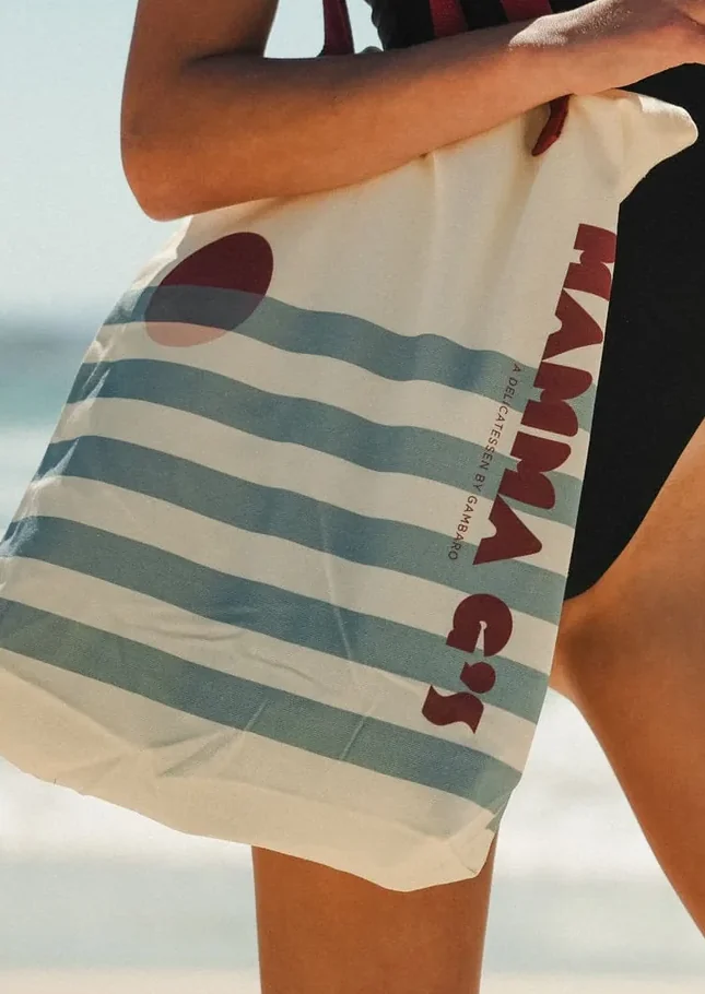 The Mamma G's canvas tote in blue and cream stripe with the red wordmark